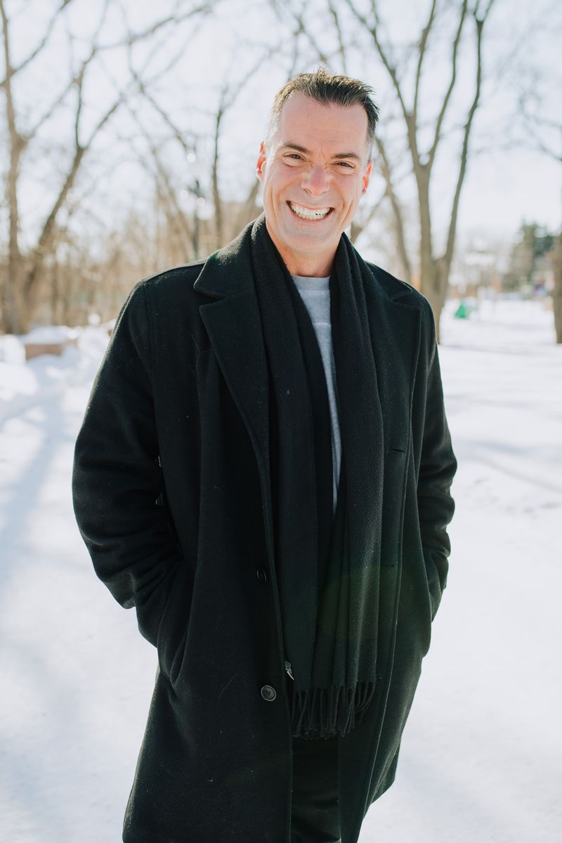 Joe Marcoux in a winter coat, smiling, somewhere in Canada