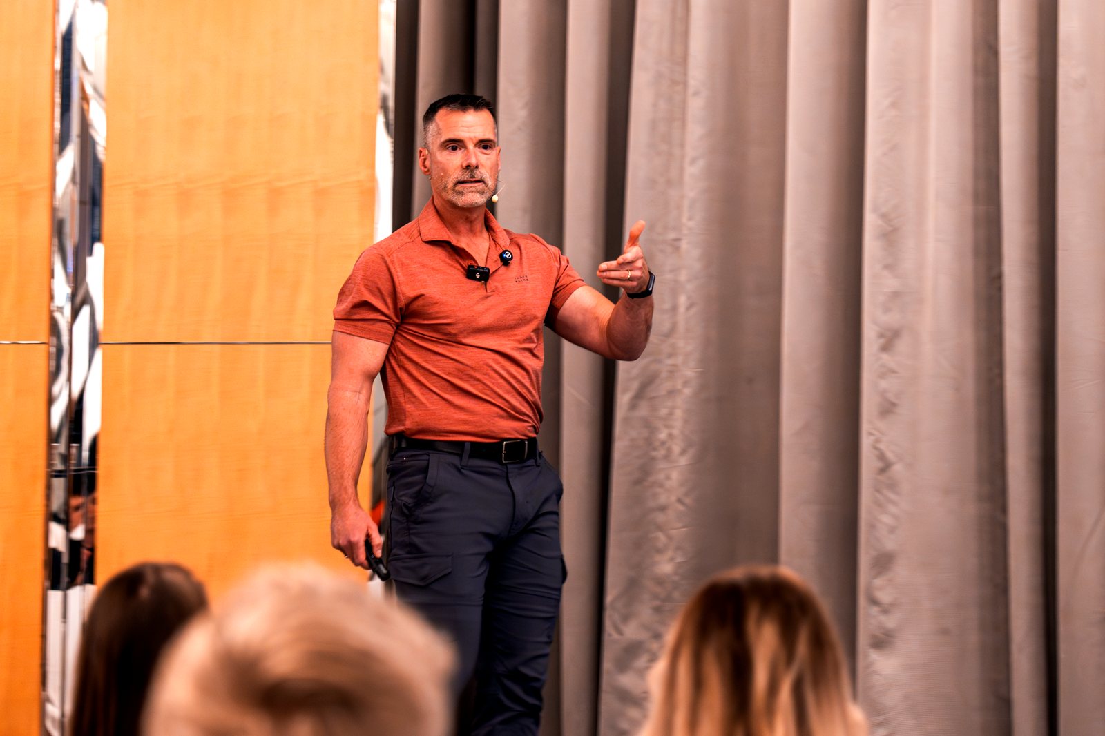 Joe Marcoux presenting on stage to a live audience